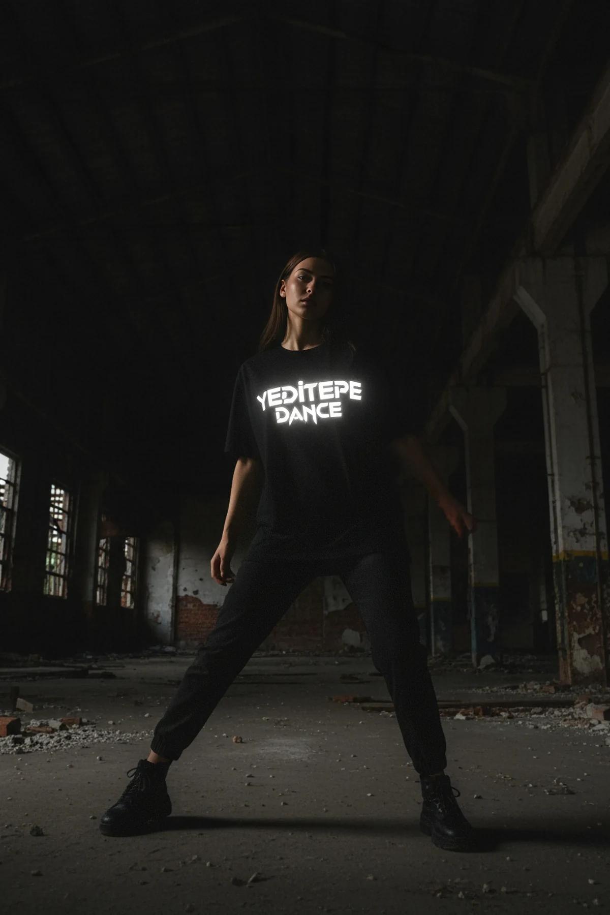 close-up reflective chest print on black heavyweight jersey tee showing bright glow effect