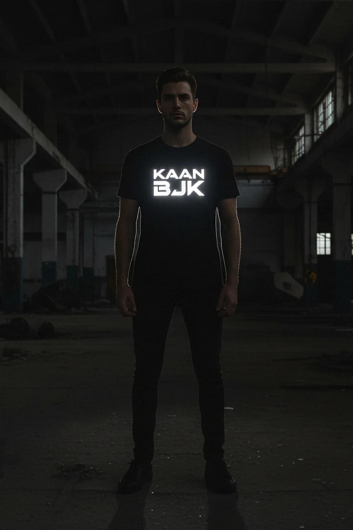close-up of retroreflective chest logo on black oversized t-shirt activating under direct flash