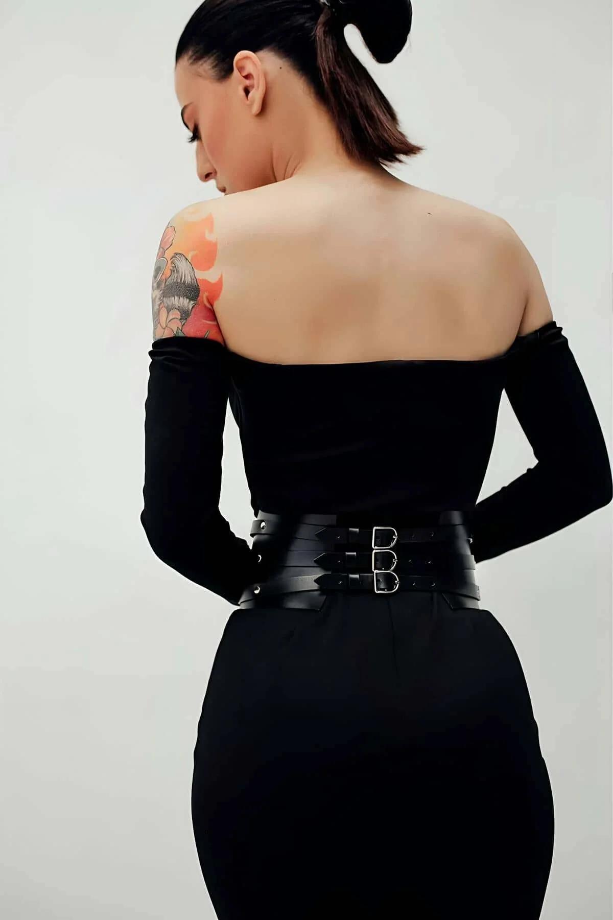 close-up of sharp V-point front panel on black faux leather waist cinch belt with dome rivet accents