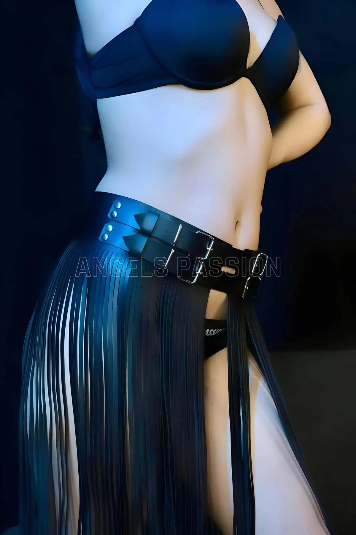 Close-up of silver-tone double prong buckles on wide black faux leather waist belt