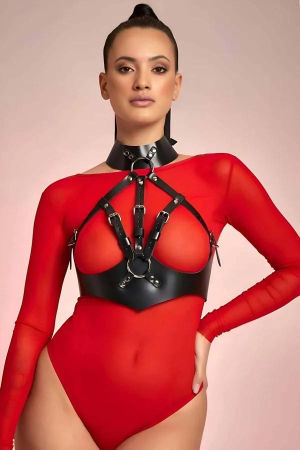 Black faux leather strappy halter neck body harness with O-rings and adjustable buckle straps worn over red mesh bodysuit