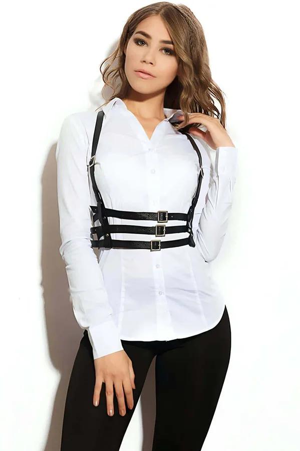 Black faux leather triple strap chest harness with gold rectangular buckles worn over white shirt