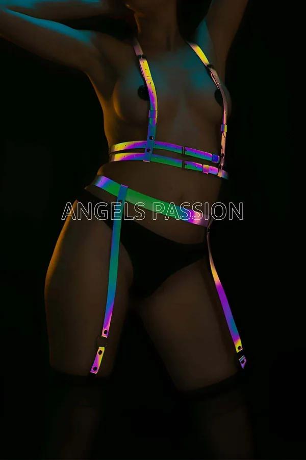 Rainbow reflective body harness and garter set with iridescent holographic straps and silver buckles on dark background