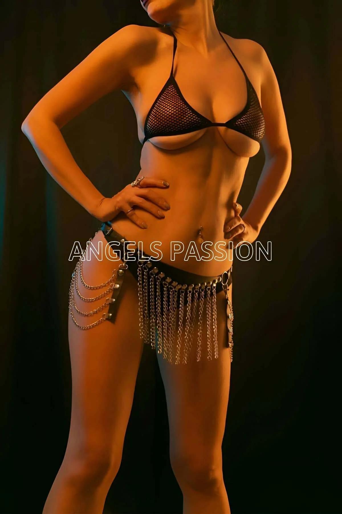 Faux leather fringe hip harness styled over dark fabric, showing full chain length and waistband width