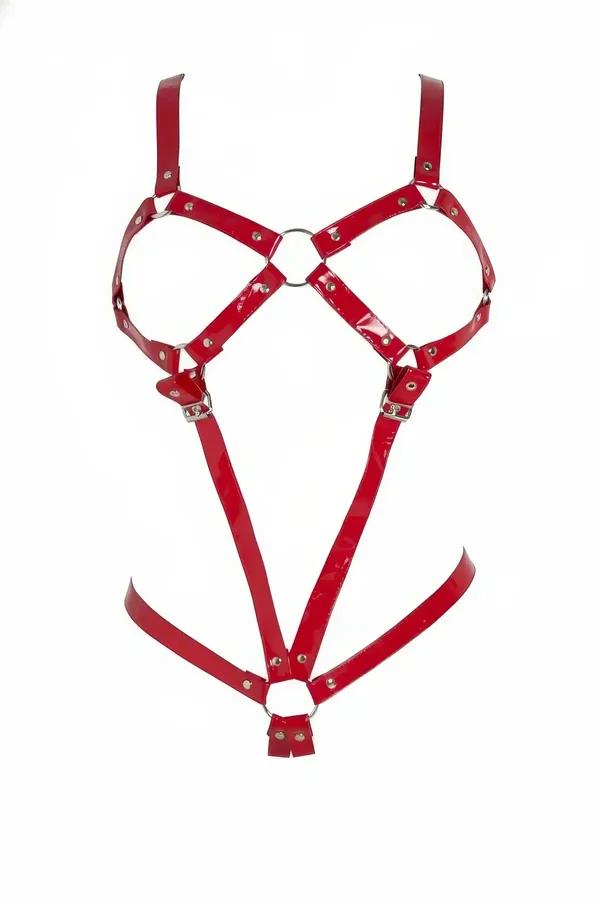 Shiny red patent faux leather body harness with dual silver O-rings and stud hardware, full torso silhouette on white backgro