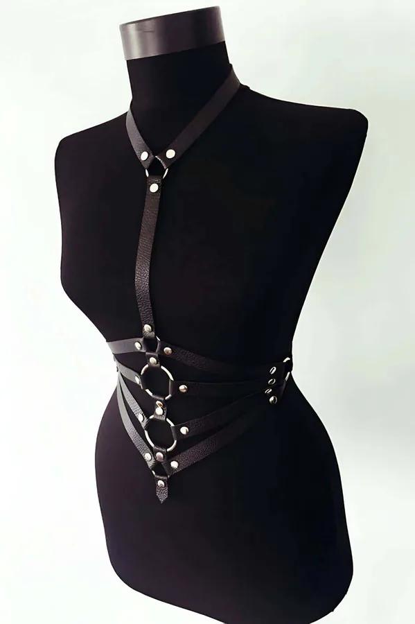 Black faux leather chest harness with three stacked hexagonal O-rings and silver rivet studs on mannequin