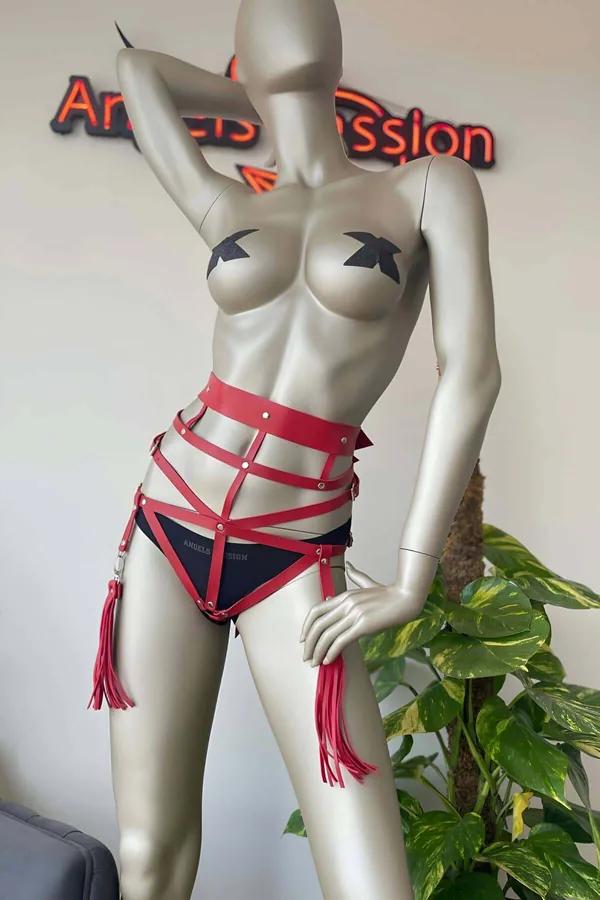 red faux leather waist cage harness set with silver studs black underwear and tassel fringe thigh straps on mannequin