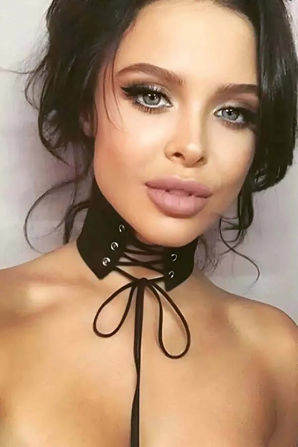 black faux suede lace-up choker with silver eyelets and long adjustable front tie straps worn at neck