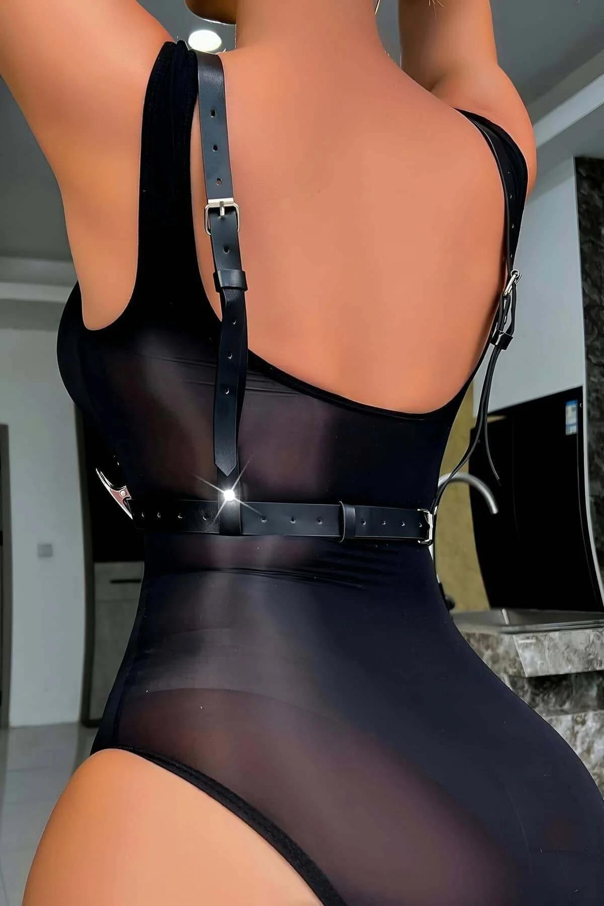 Close-up of silver zinc alloy O-rings and rhinestone rivets on black PU faux leather V-cut harness straps