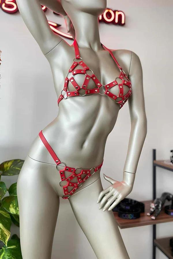 Red faux leather caged bra and thong harness set with silver O-rings and rivet hardware on mannequin