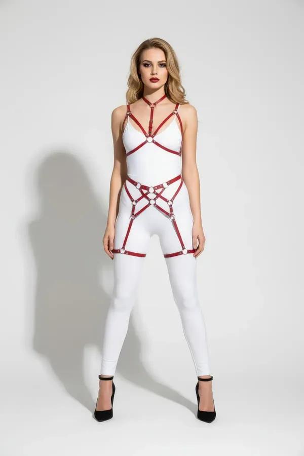 Red faux leather multi-strap O-ring body harness and thigh garter set with silver hardware worn over white bodysuit