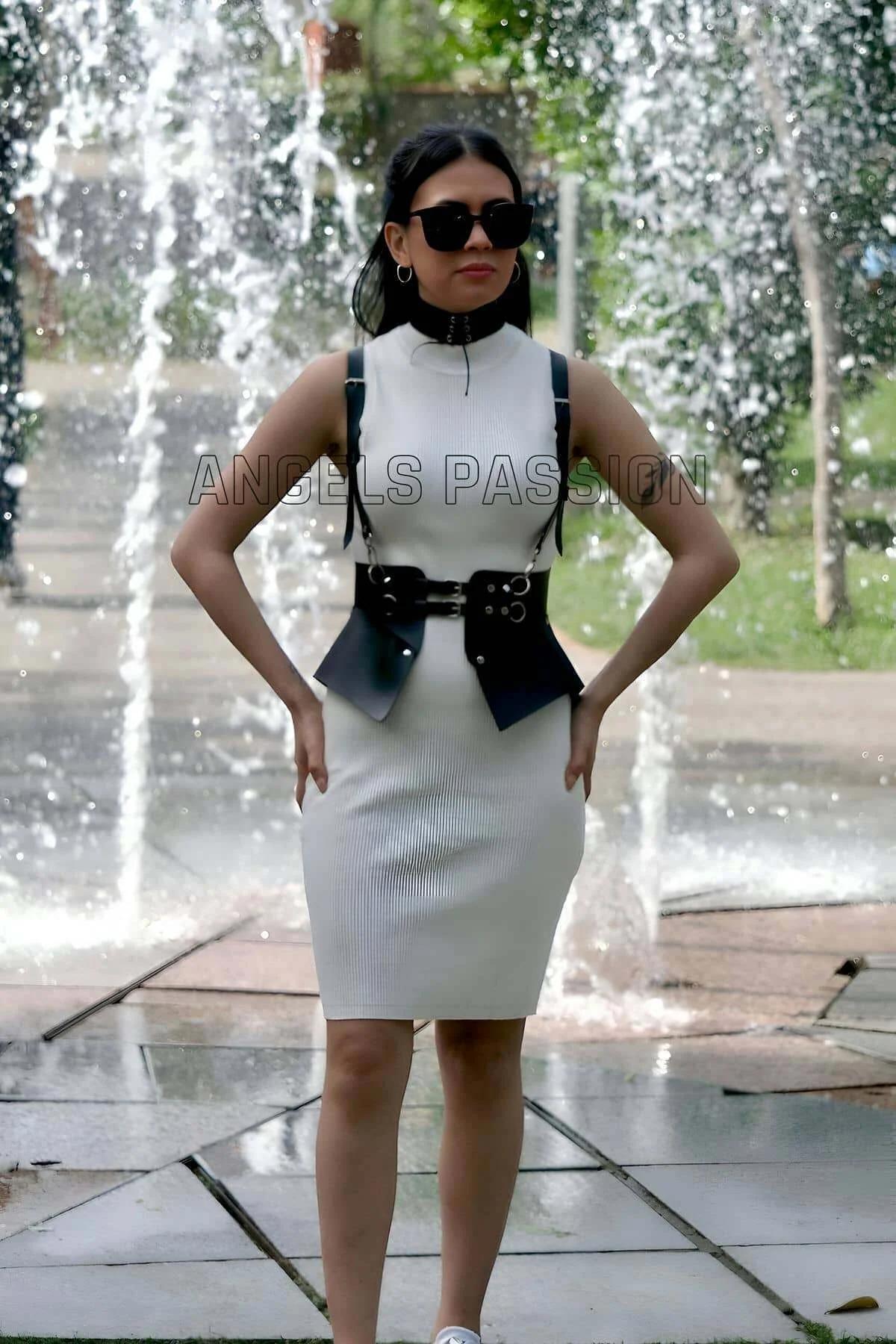 Side view of black faux leather peplum-style hip panels on structured waist harness