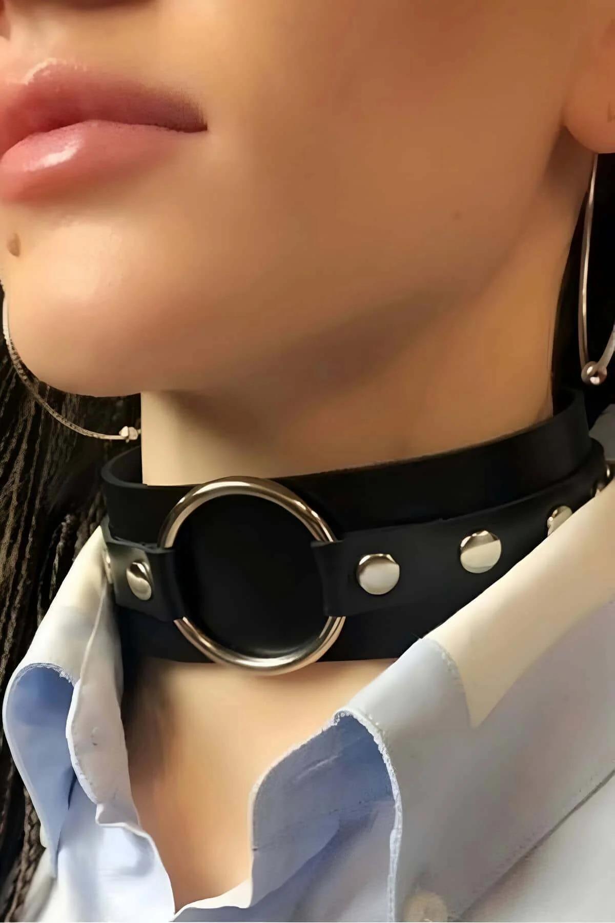close-up of silver O-ring rivet detail on black faux leather wide choker band