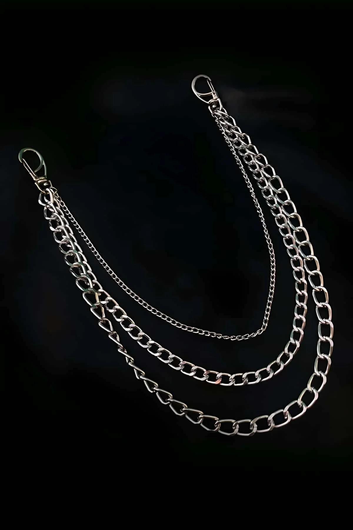 Close-up of silver-tone wide curb chain link detail from layered necklace set
