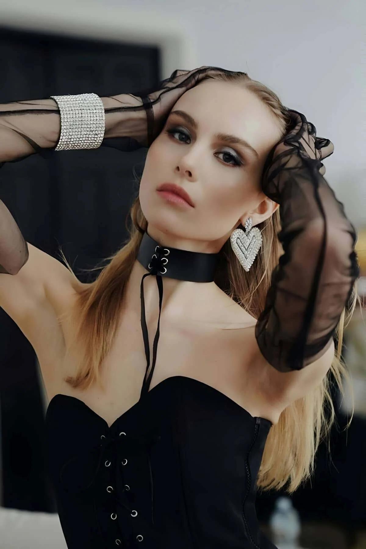 Adjustable lace-up back closure of black faux leather choker with trailing tie ends