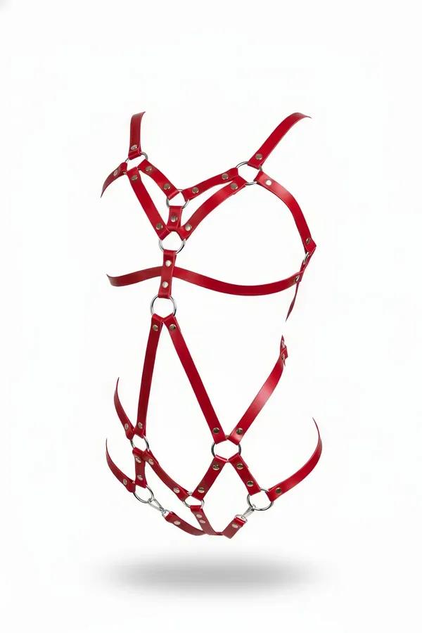 Strappy red faux leather body harness with silver O-rings across chest waist and hip bands on white background