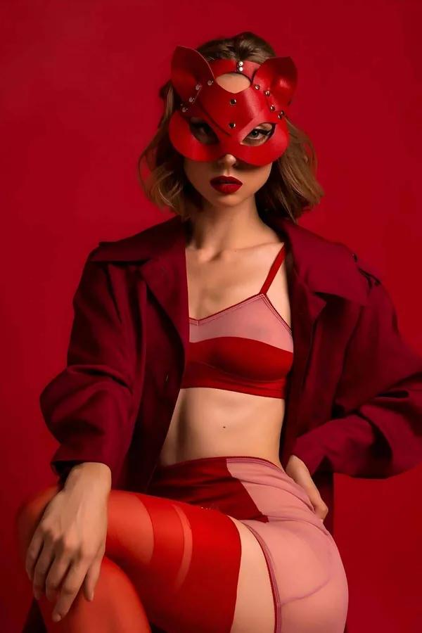 Red faux leather cat eye mask with rounded ears and silver crystal studs on white background