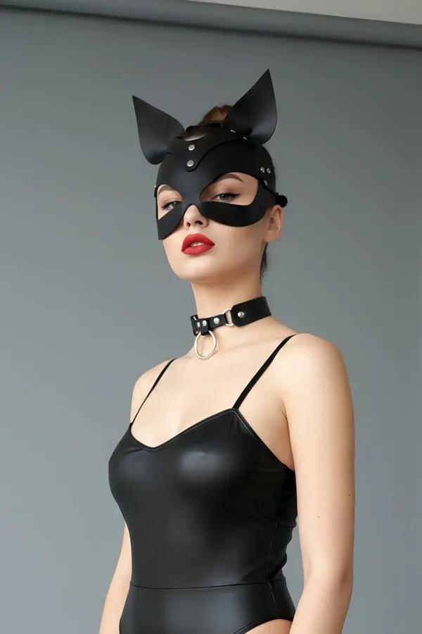Black matte faux leather cat mask with stand-up ears and silver rivets worn with matching O-ring choker