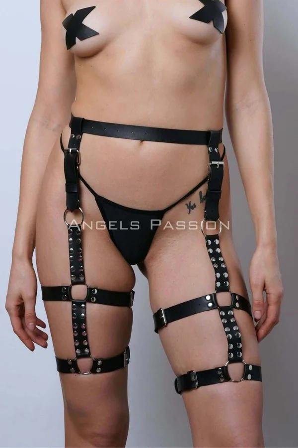 Black faux leather leg harness with silver rivet-studded straps and caged thigh panels connected by chrome O-rings