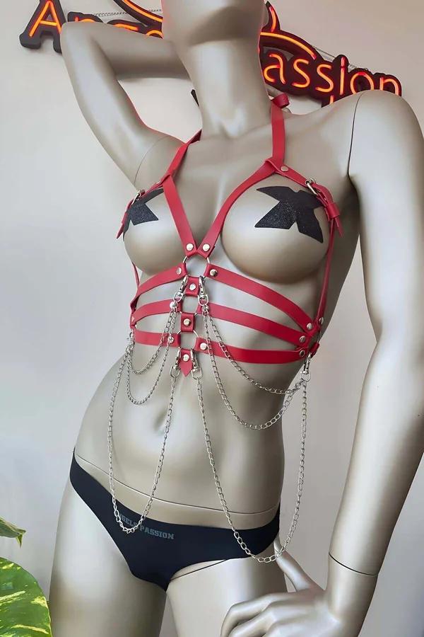 red faux leather chest harness with silver O-ring and 4 draped chain strands on mannequin front view