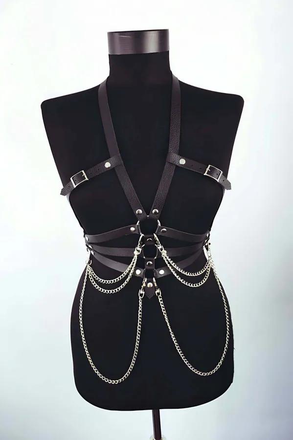 Black vegan leather chest harness with silver swinging chain and O-ring detail on model