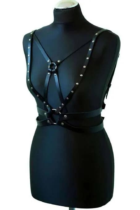 black PU vegan leather chest harness O-ring and silver rivet detail cross strap geometry on model
