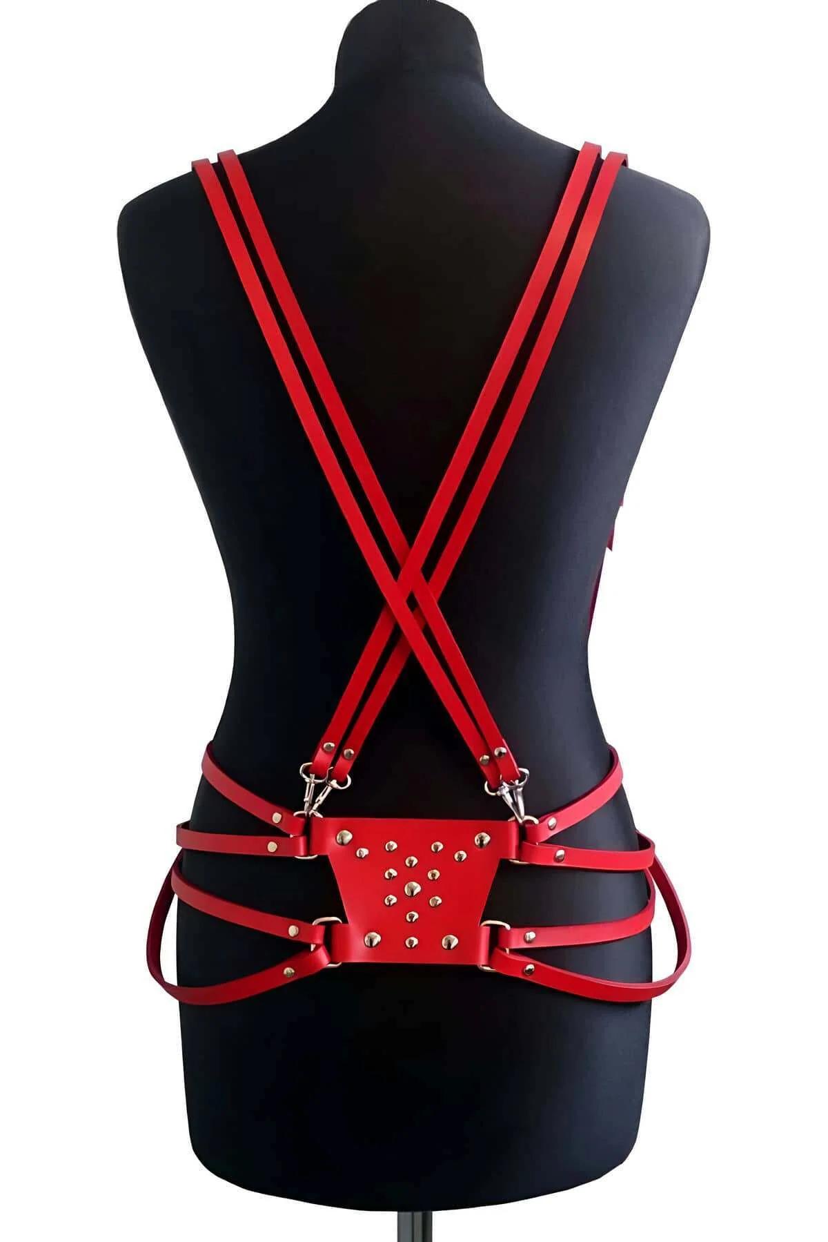 Side view of red studded body harness showing waist panel width and strap layout