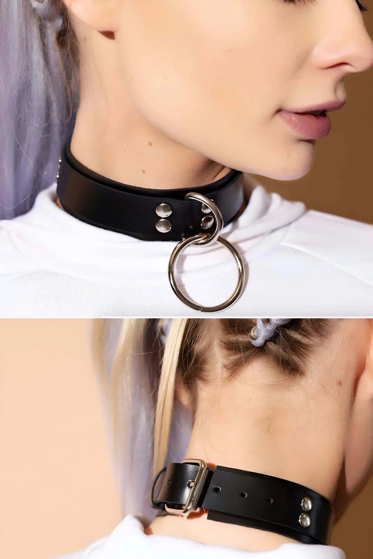 close-up of silver O-ring and rivet studs on black PU leather choker band
