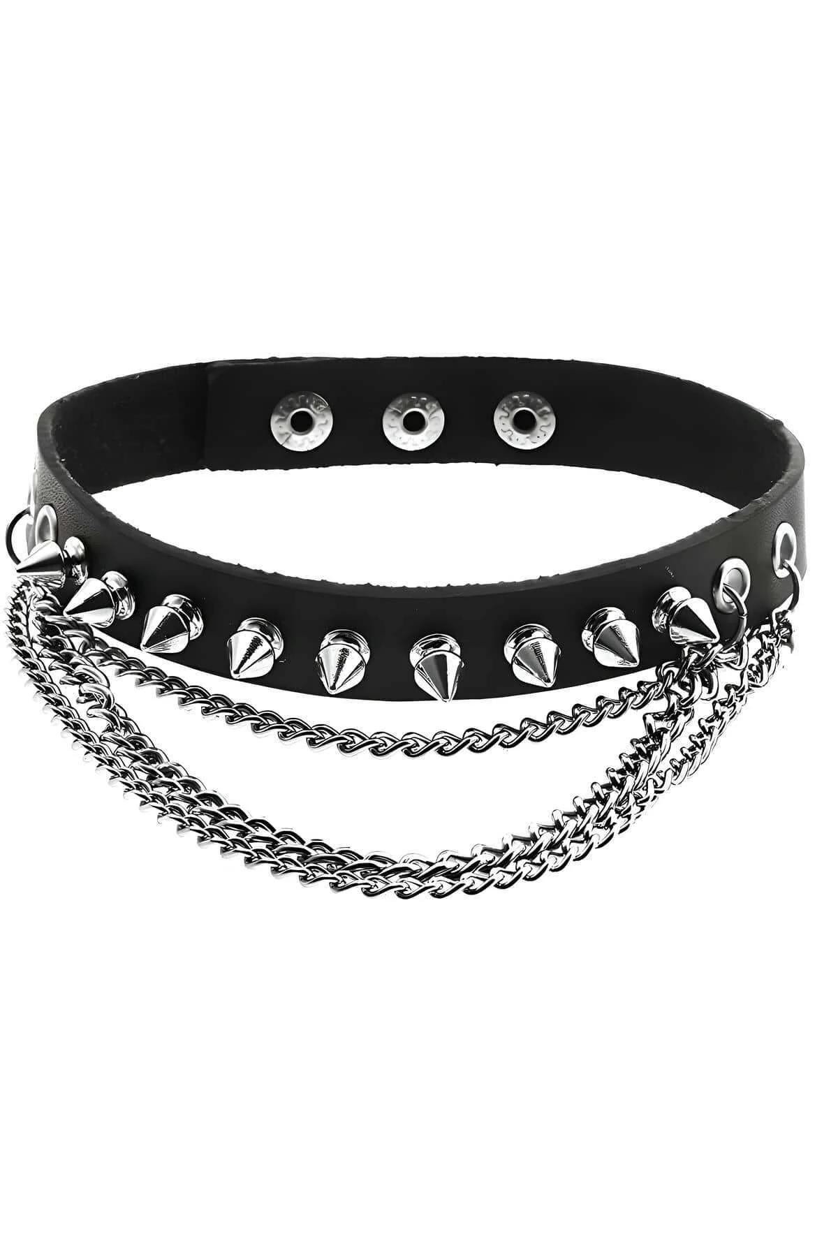 Layered silver chain and black spike choker worn together at collarbone level
