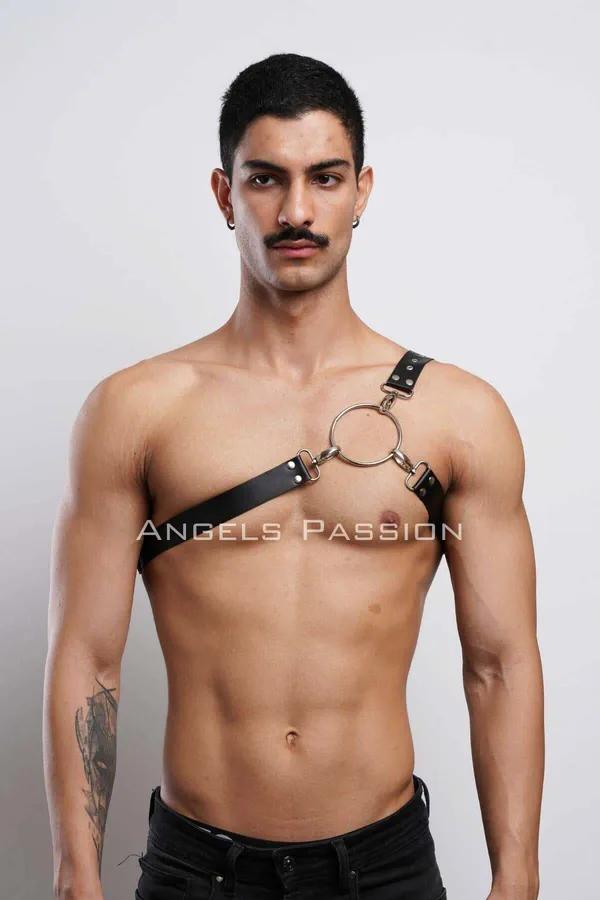 Black faux leather O-ring chest harness single diagonal strap with gold-tone hardware worn by man