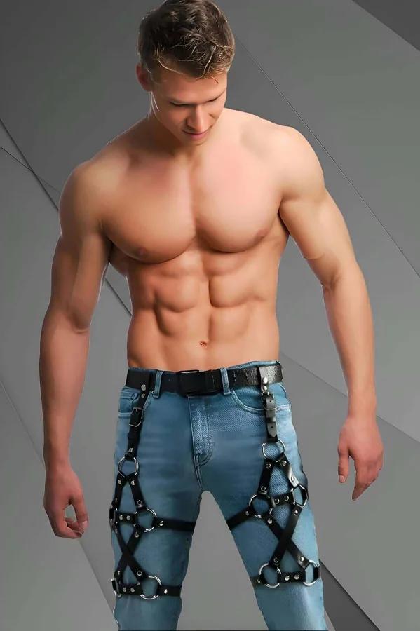 black faux leather leg harness with silver O-rings worn over light blue jeans, adjustable thigh straps and buckles