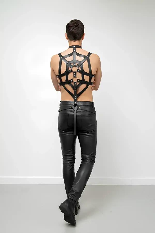 black faux leather full body harness with geometric web strap pattern and silver rivets on male model back view