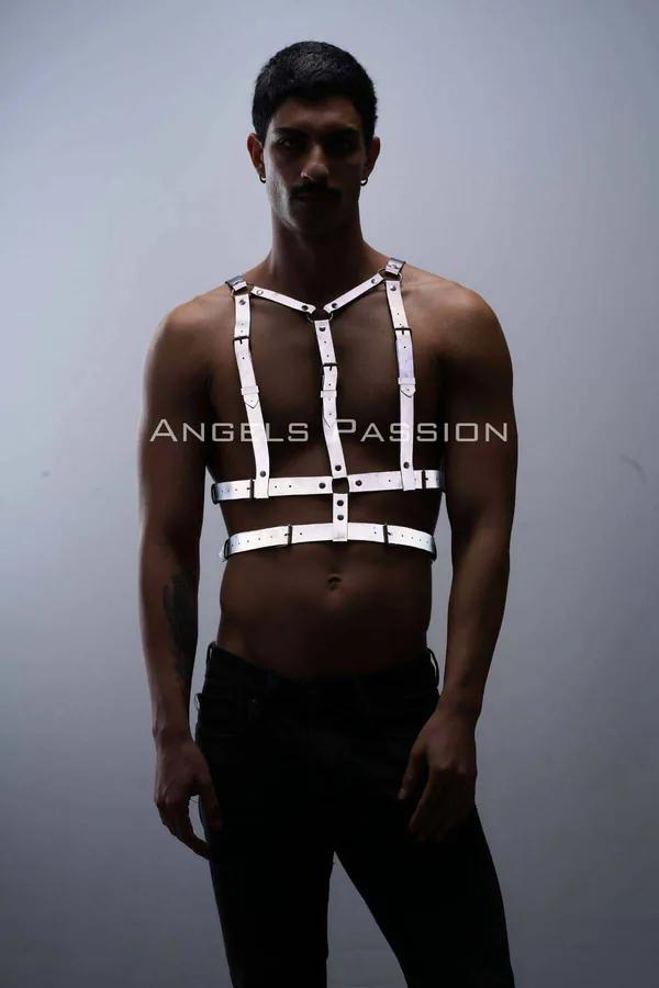 White reflective chest harness with silver buckles on male model, adjustable Y-frame strap design over bare chest