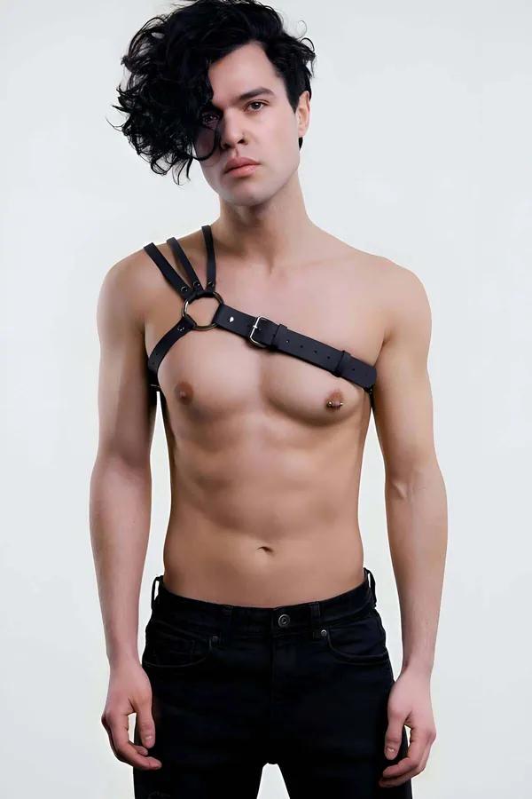 Black faux leather single-shoulder chest harness with silver O-ring and buckle on male model