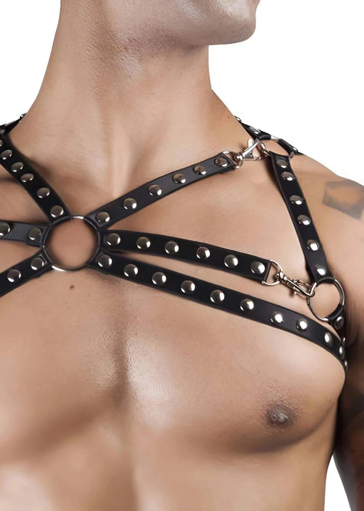close-up of silver dome studs and central O-ring on black faux leather chest harness