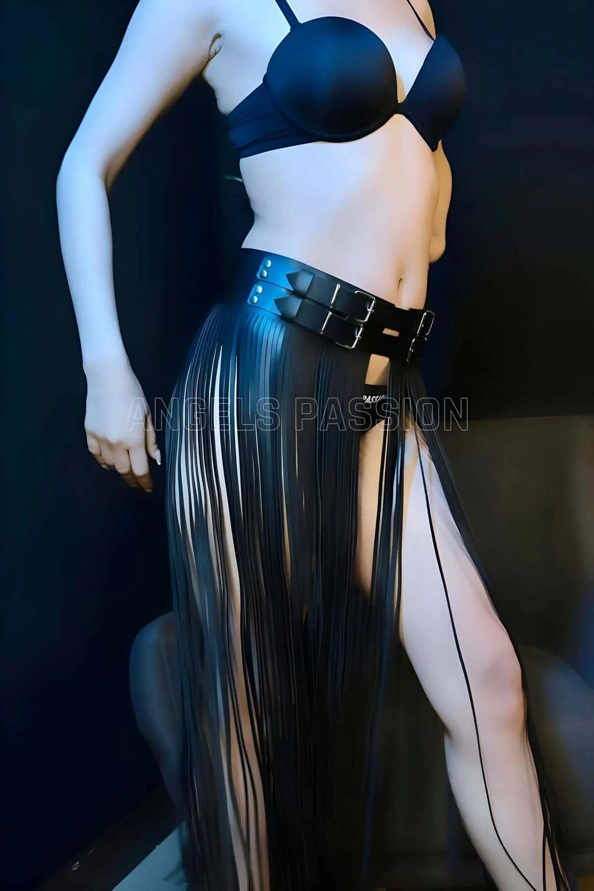 Black faux leather fringe skirt harness with wide double buckle belt and floor-length narrow fringe strips