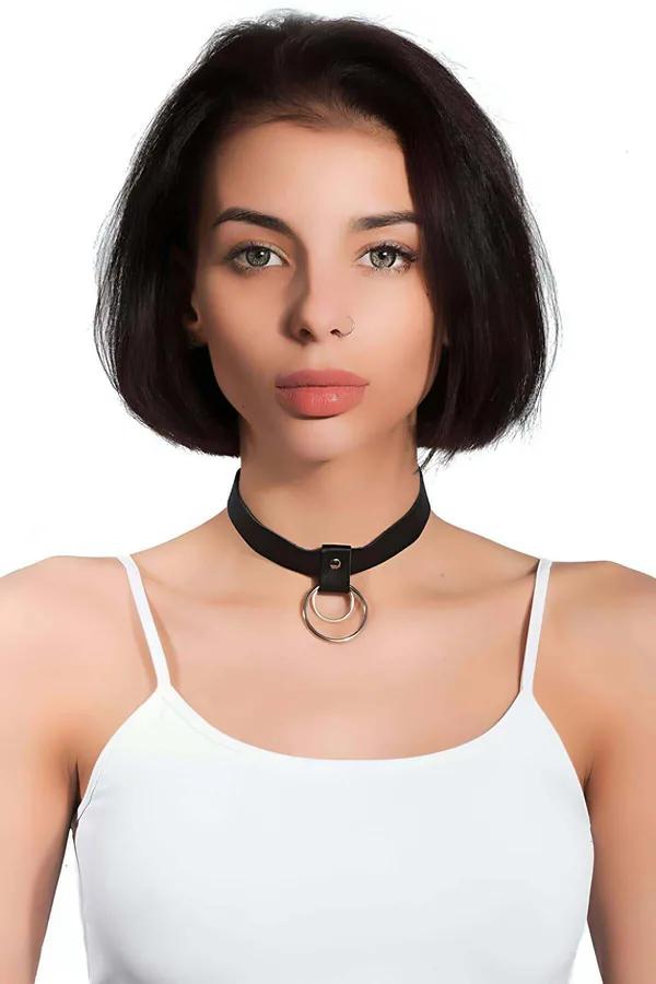 Black faux leather choker necklace with two stacked silver O-rings worn at collarbone, matte band approximately 2.5 cm wide