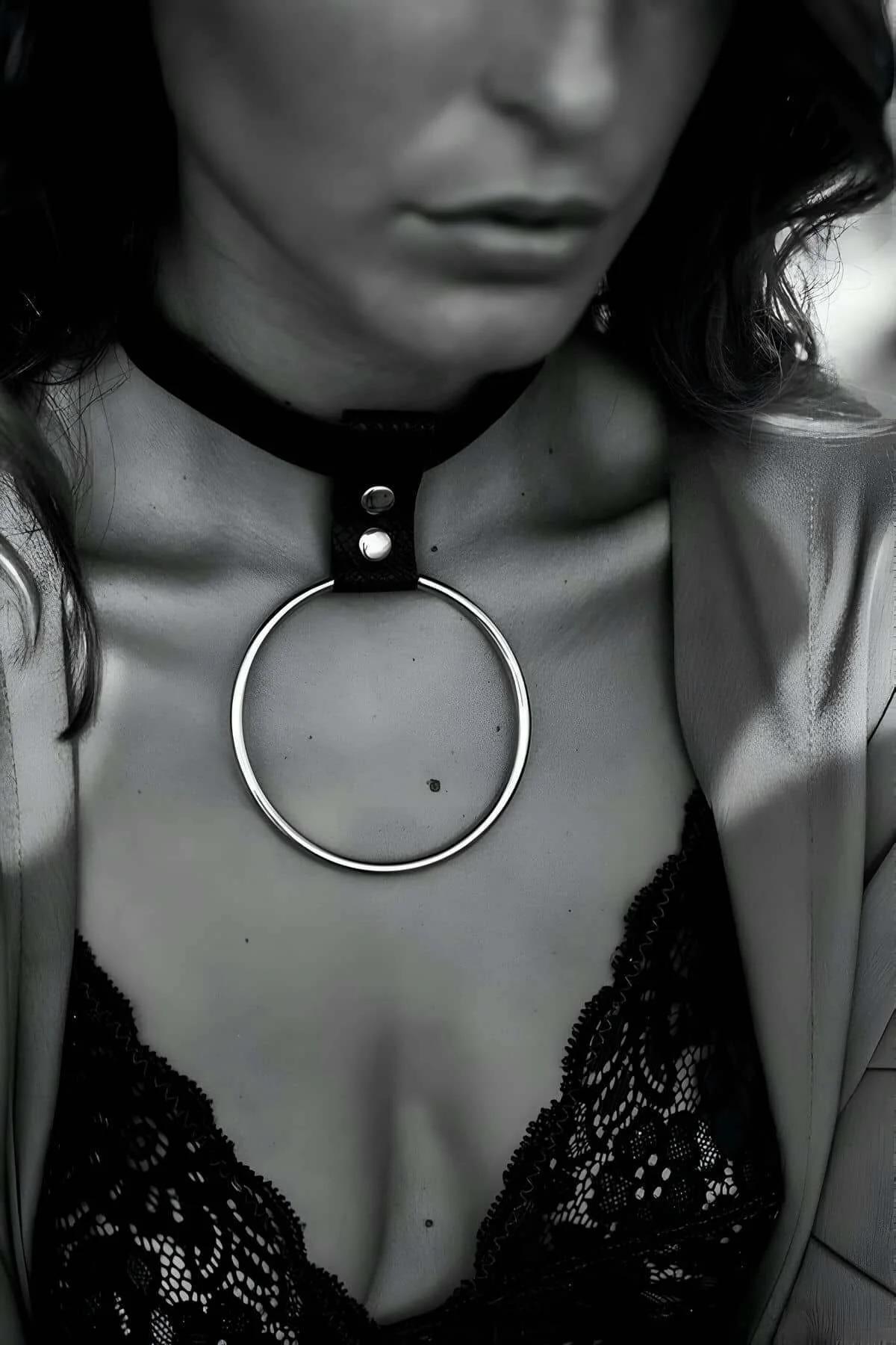 black vegan leather choker necklace with large silver O-ring pendant worn at collarbone