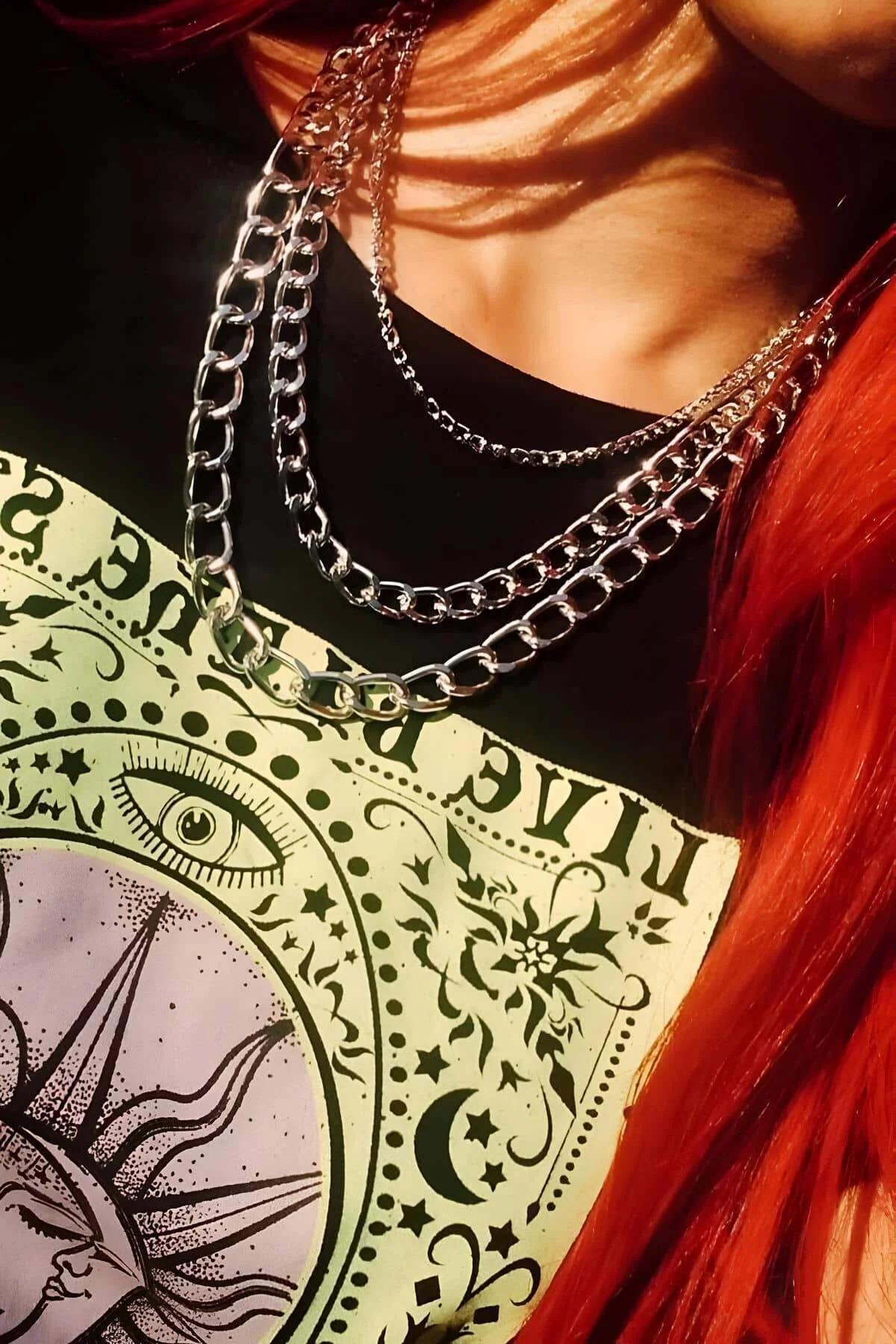 Silver layered chain necklace set with wide curb, cable, and fine mixed links worn at collarbone level